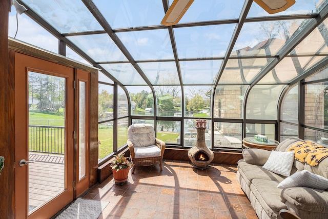 sunroom / solarium featuring vaulted ceiling