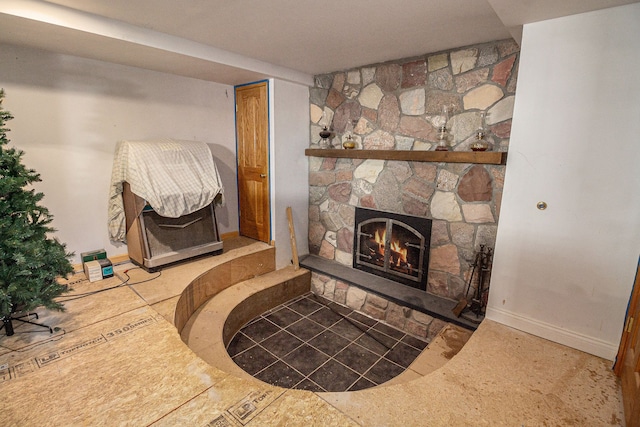 detailed view of a stone fireplace and baseboards