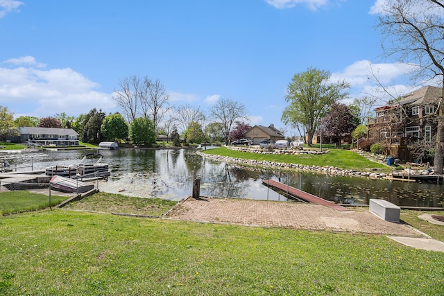 dock area featuring a water view and a yard