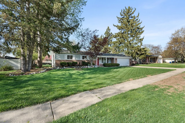 5874 Thornaby Dr, Waterford, MI 48329 - ranch-style home featuring concrete driveway, a garage, a front lawn, and brick siding