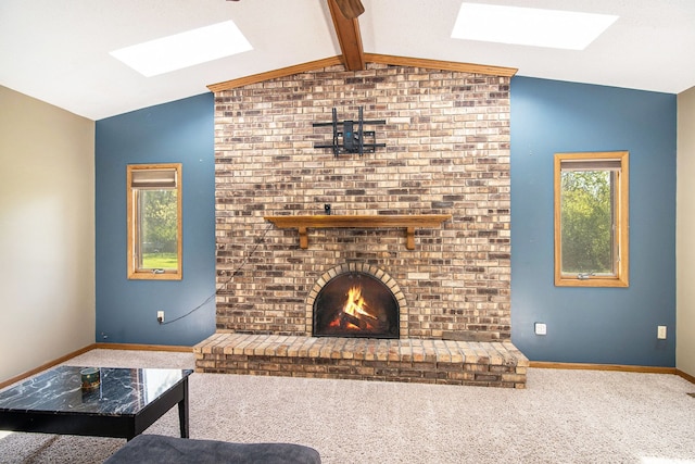 carpeted living room with a skylight, a fireplace, and baseboards