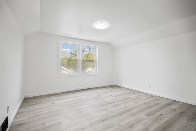 bonus room featuring light wood-type flooring, baseboards, lofted ceiling, and visible vents