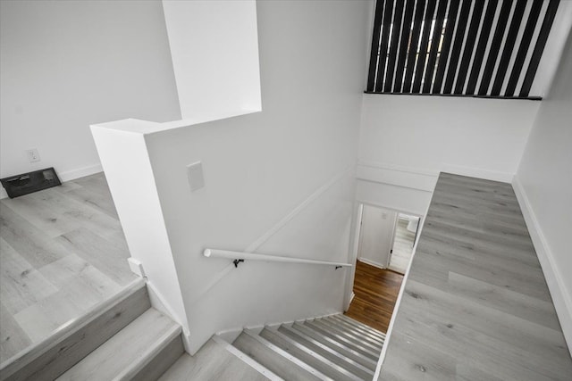 stairs featuring baseboards and wood finished floors