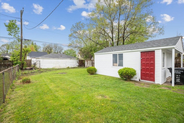 view of yard featuring an outdoor structure and a fenced backyard