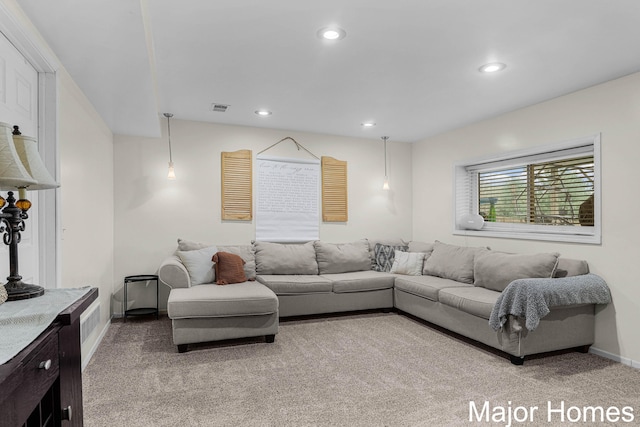 living room featuring baseboards, light carpet, recessed lighting, and visible vents