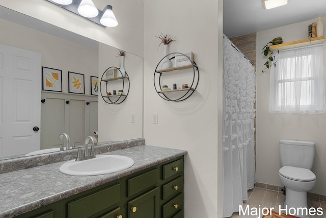 full bath featuring toilet, tile patterned flooring, and vanity