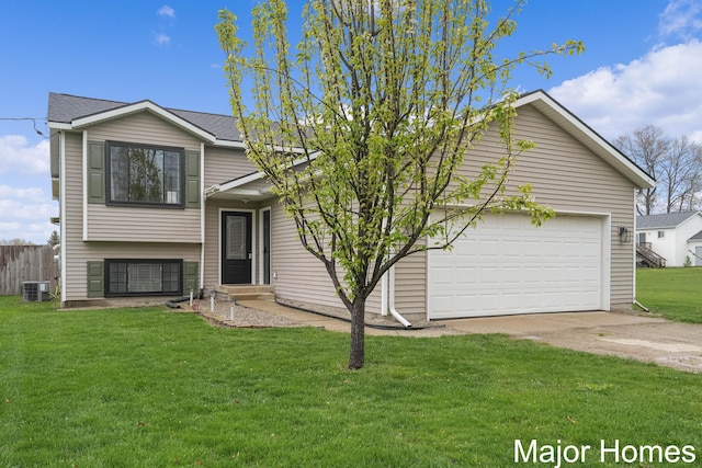 split level home with a front lawn, fence, cooling unit, concrete driveway, and an attached garage
