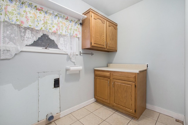 921 Fourth St, Pullman, MI 49450 - washroom with baseboards, cabinet space, and light tile patterned floors
