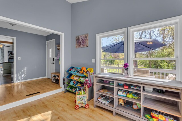 playroom with baseboards and wood finished floors