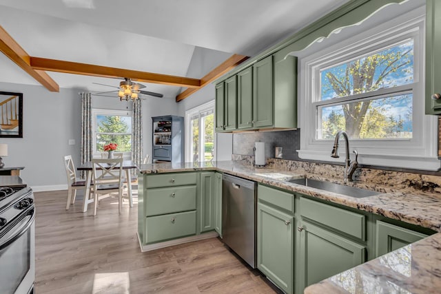 kitchen featuring a sink, lofted ceiling with beams, light wood finished floors, green cabinetry, and stainless steel appliances