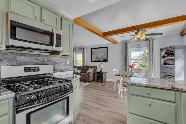 kitchen featuring beamed ceiling, appliances with stainless steel finishes, green cabinets, and a ceiling fan