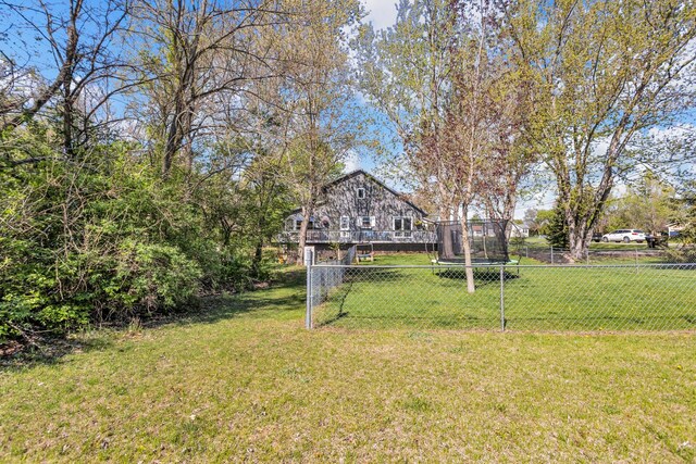 view of yard featuring fence and a trampoline