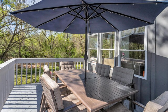 deck with outdoor dining area