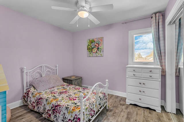 bedroom featuring baseboards, ceiling fan, and wood finished floors