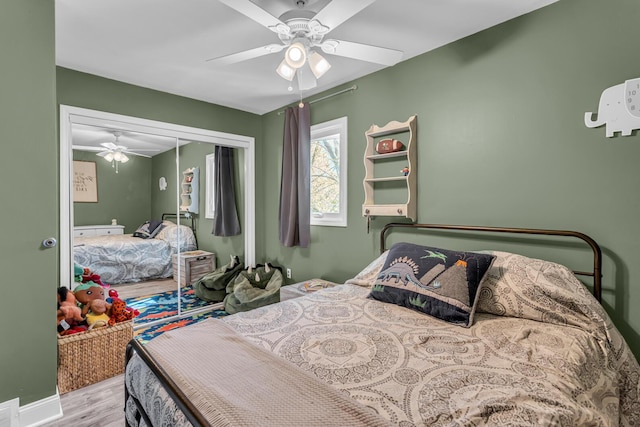 bedroom featuring a closet, a ceiling fan, and wood finished floors