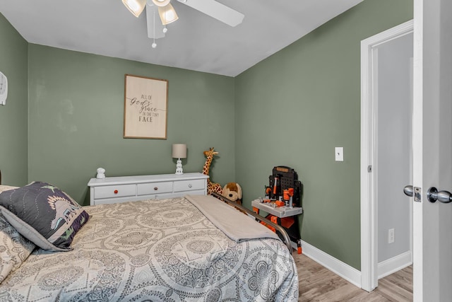 bedroom featuring baseboards, a ceiling fan, and light wood finished floors