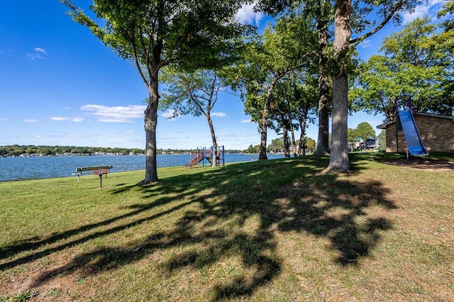 view of yard with a water view and a playground
