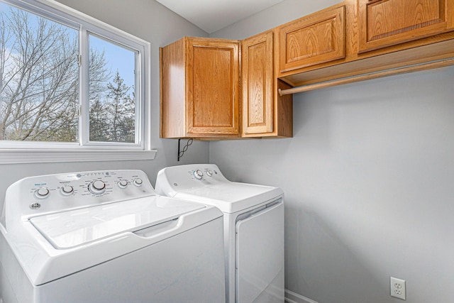 laundry room with cabinet space, separate washer and dryer, and a wealth of natural light