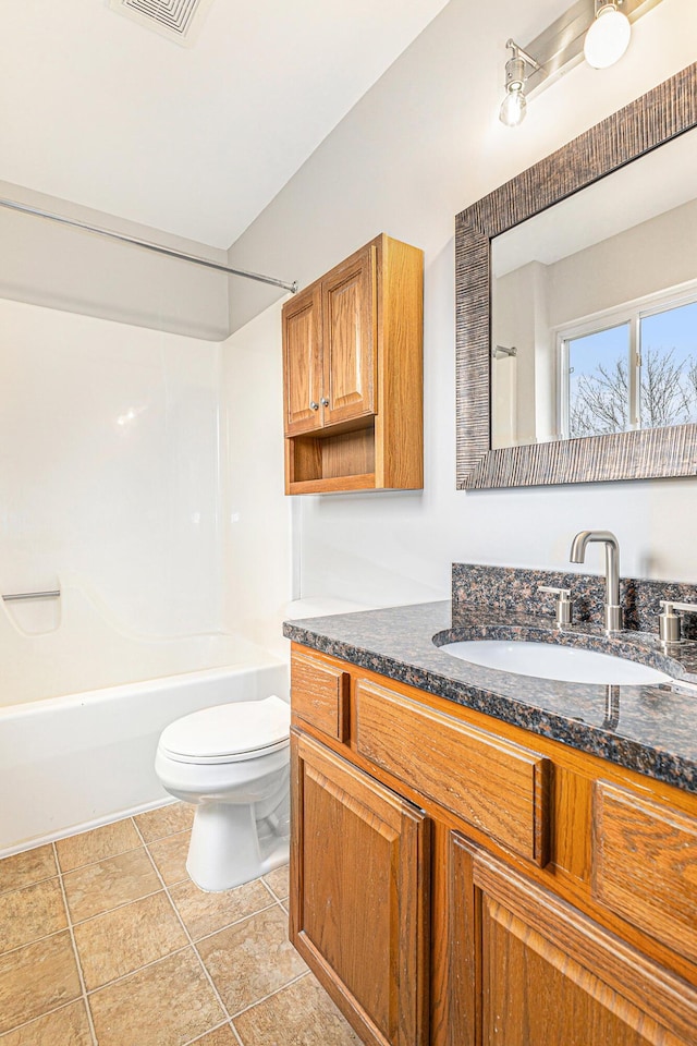 bathroom featuring visible vents, vanity, tile patterned floors, toilet, and tub / shower combination