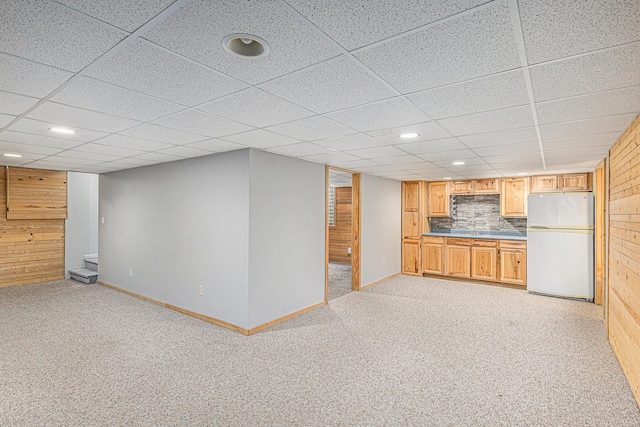 interior space with a sink, baseboards, freestanding refrigerator, light carpet, and recessed lighting
