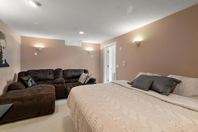 bedroom featuring recessed lighting, a textured ceiling, and light colored carpet