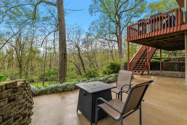 view of patio / terrace featuring a wooden deck and stairway