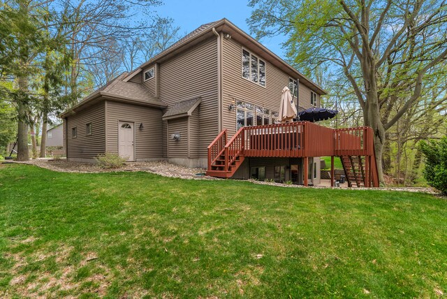 back of property featuring a yard, a deck, and stairs