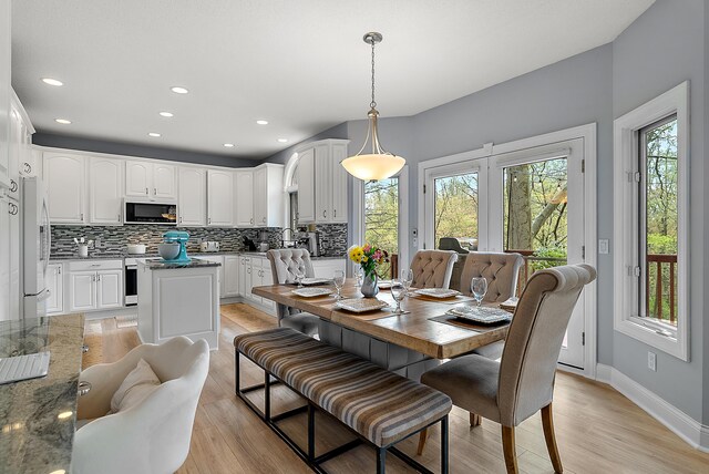 dining area with recessed lighting, baseboards, and light wood finished floors