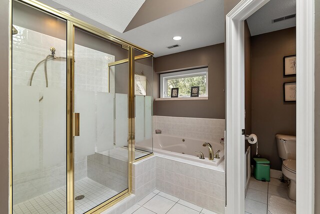 bathroom featuring visible vents, tile patterned floors, a bath, and toilet