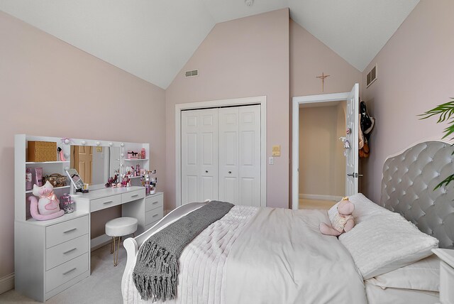 bedroom featuring visible vents, a closet, light carpet, and high vaulted ceiling