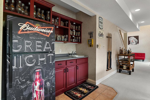 bar with indoor bar, recessed lighting, light colored carpet, a sink, and light tile patterned floors