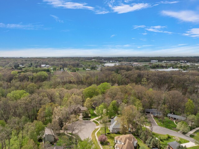 birds eye view of property with a wooded view