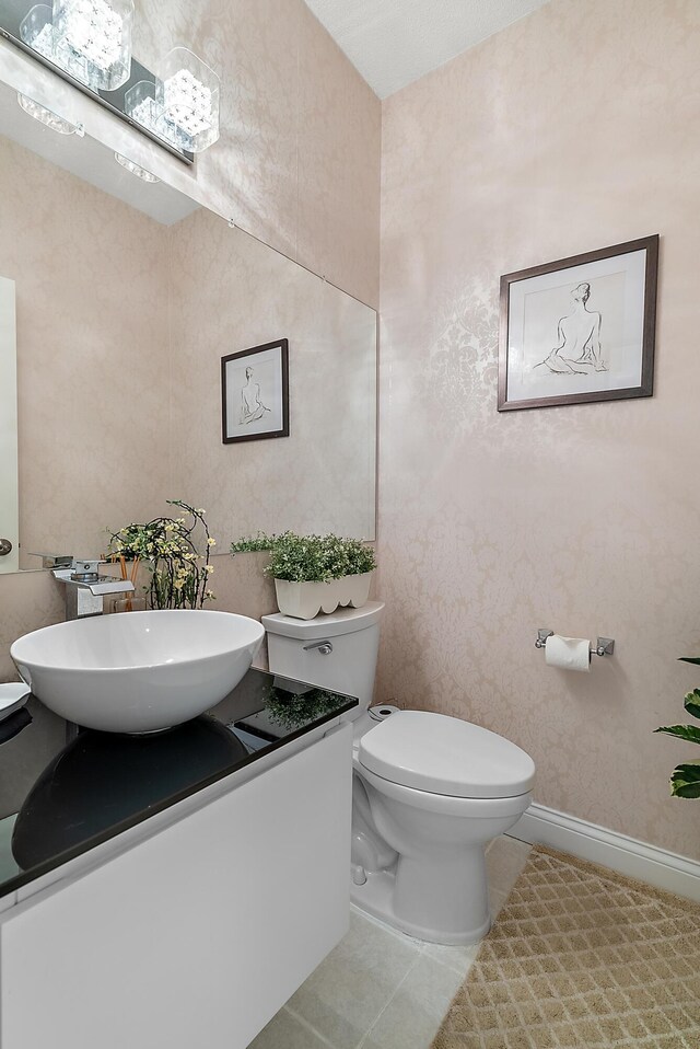 bathroom featuring toilet, tile patterned floors, and vanity