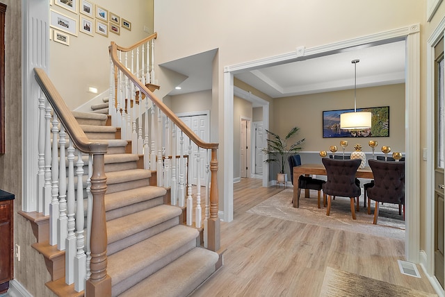 stairs featuring baseboards, visible vents, and wood finished floors