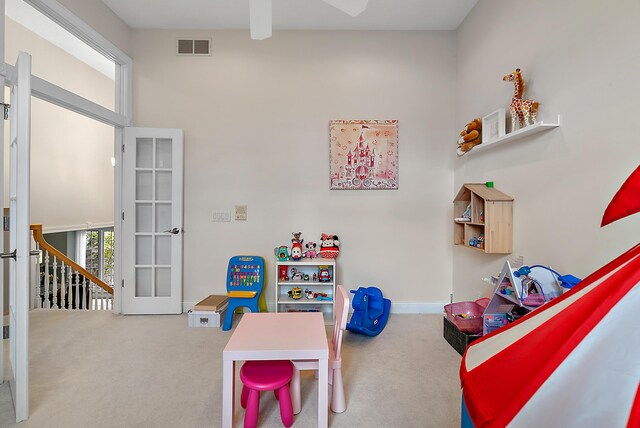 game room with carpet floors, visible vents, baseboards, ceiling fan, and french doors