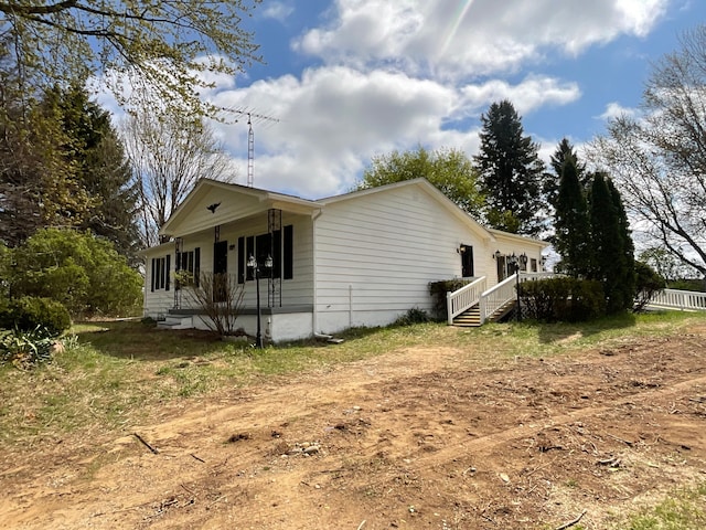 view of property exterior featuring a porch