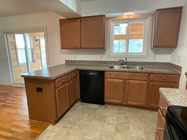 kitchen with electric range, a peninsula, dark countertops, a sink, and dishwasher
