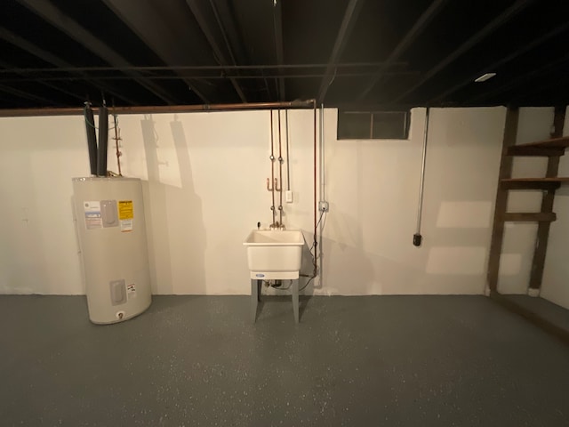 unfinished below grade area with a sink and electric water heater