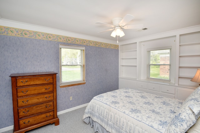 carpeted bedroom with multiple windows, baseboards, a ceiling fan, wallpapered walls, and crown molding