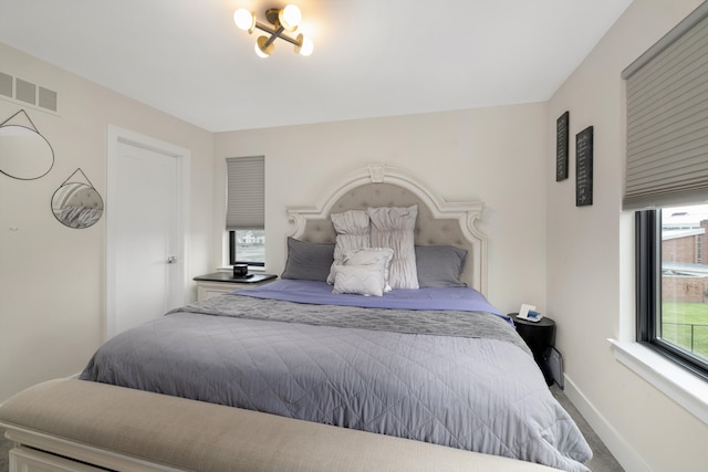 1049 Hampton Cir Unit 44, Detroit, MI 48207 - bedroom with carpet flooring, visible vents, and baseboards