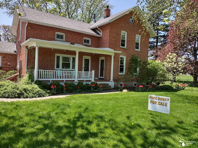 6603 S Stony Creek Rd, Monroe, MI 48162 - traditional-style house with covered porch, brick siding, a chimney, and a front yard
