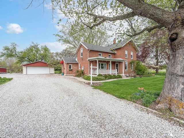 6603 S Stony Creek Rd, Monroe, MI 48162 - view of front of home with brick siding, a detached garage, a porch, a front yard, and an outdoor structure