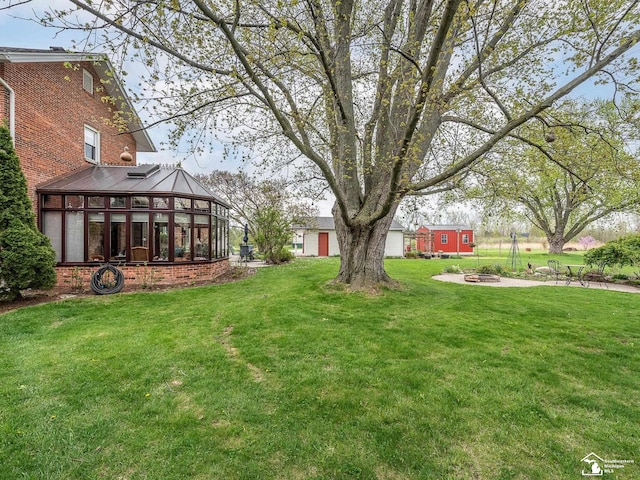 6603 S Stony Creek Rd, Monroe, MI 48162 - view of yard with a sunroom and an outdoor fire pit