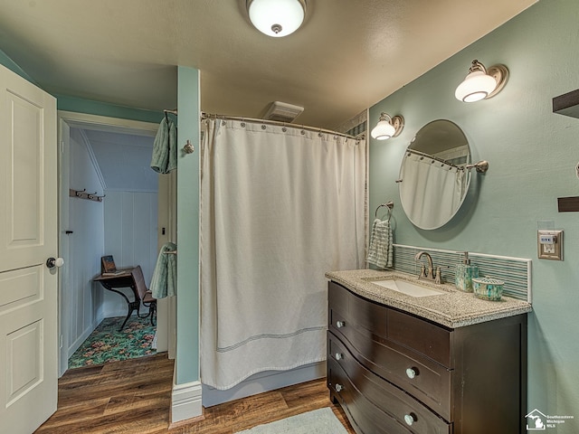 6603 S Stony Creek Rd, Monroe, MI 48162 - bathroom featuring vanity, curtained shower, wood finished floors, and visible vents