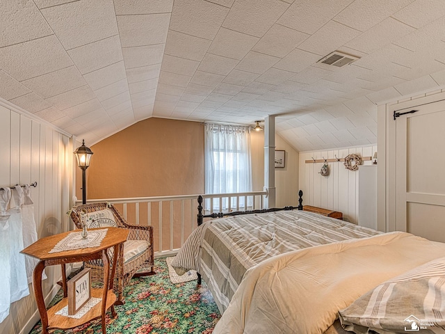 6603 S Stony Creek Rd, Monroe, MI 48162 - bedroom featuring a decorative wall, visible vents, carpet flooring, and lofted ceiling