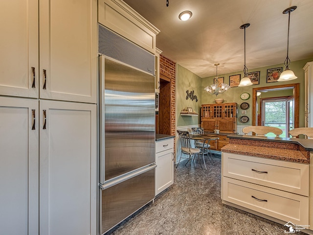 6603 S Stony Creek Rd, Monroe, MI 48162 - kitchen with white cabinets, dark countertops, an inviting chandelier, decorative light fixtures, and stainless steel built in fridge
