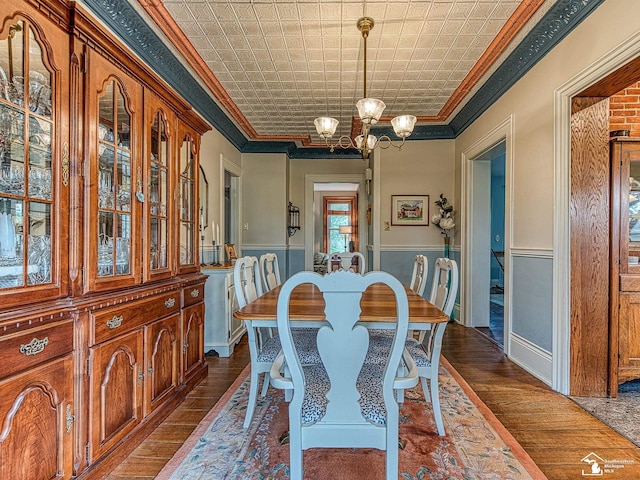 6603 S Stony Creek Rd, Monroe, MI 48162 - dining room featuring an ornate ceiling, ornamental molding, dark wood-type flooring, and a notable chandelier