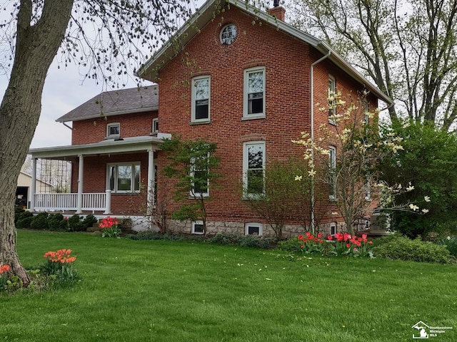 6603 S Stony Creek Rd, Monroe, MI 48162 - rear view of property featuring a porch, brick siding, a chimney, and a lawn