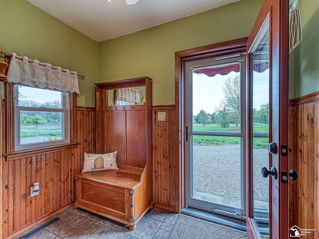 6603 S Stony Creek Rd, Monroe, MI 48162 - doorway to outside with wood walls, wainscoting, and visible vents