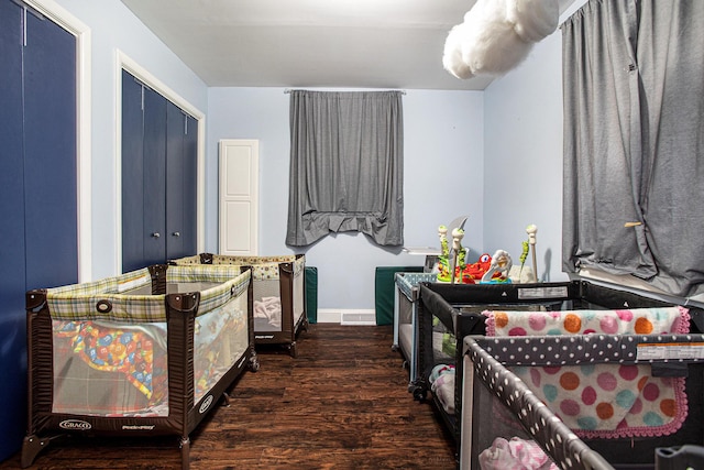 bedroom with visible vents and wood finished floors